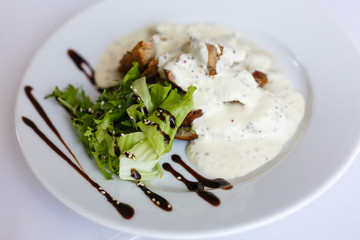 Meat and mustard sauce in a white plate