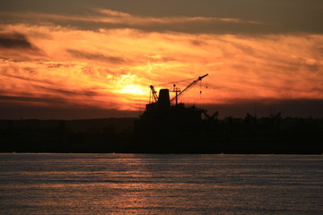 Fototapeta na wymiar Silhouette Chemical factory crane. sunset sky
