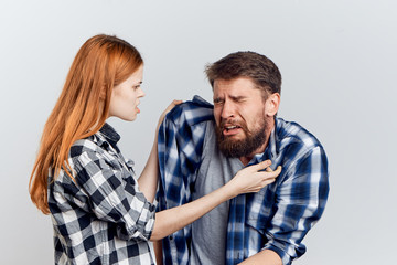 Beautiful young woman and guy with a beard on white isolated background, repair, housework, painting, building materials