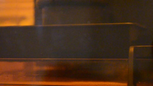 DPL 3d printer create small detail and liquid drips, platform slowly move from vat with liquid close-up. Progressive modern additive technology 3D printing, create scaled model by UV polymerization