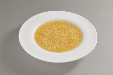 Plate with a portion of pasta in broth