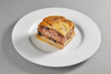 Round dish with a portion of Greek moussaka