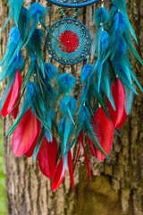 Dreamcatcher made of feathers, leather, beads, and ropes