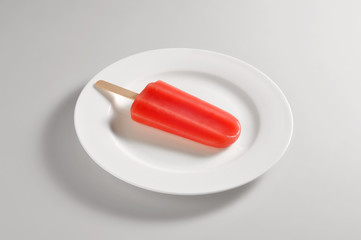 Round dish with red ice lolly