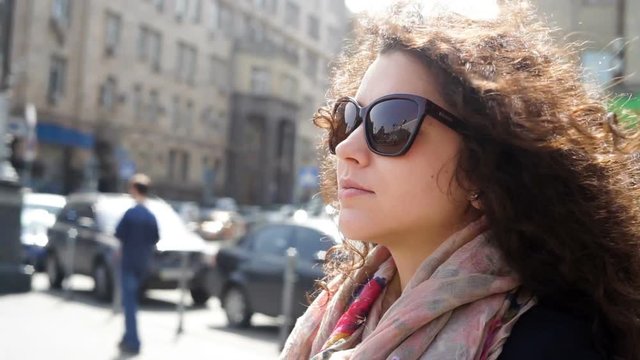 Beautiful young woman in sunglasses in the city