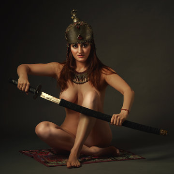Female in antique bousani jewellery and wedding helmet with sword
