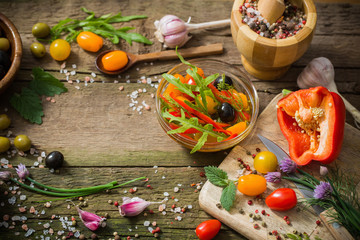 vegetables and olives on old wooden background