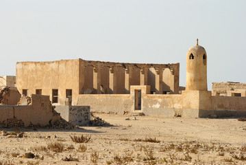 Ruins of abandoned village Al-Jumail in Qatar, with minaret of ruined mosque. 