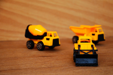 Group of small heavy construction machine toy, lorry, bulldozer and concrete mixer. All made of...