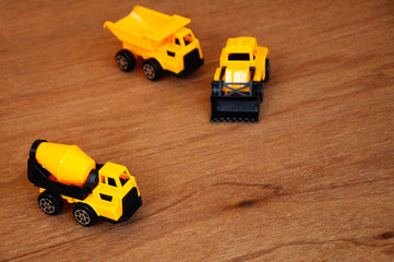 Group of small heavy construction machine toy, lorry, bulldozer and concrete mixer. All made of...