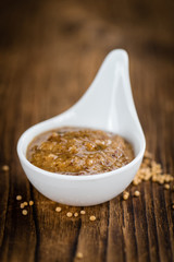 Wooden table with Sweet Mustard (selective focus)