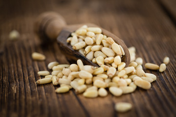 Wooden table with Pine Nuts (selective focus)