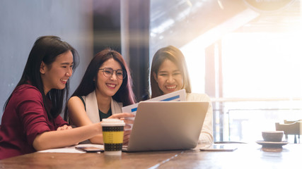 3 teenagers friends meet in coffee shop, using technology device  together