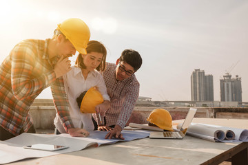 three construction engineers working outdoors in construction site