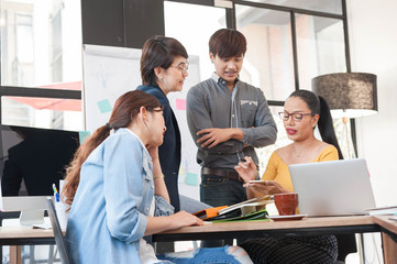 group of four multi generation of creative work place, modern style of work, entrepreneur group brainstorming