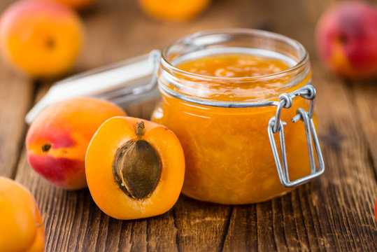 Apricot Jam on wooden background (selective focus)