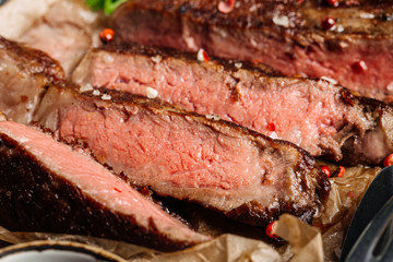 Beef rump steak from marble beef medium rare with sauce on wood plate, close-up. Selective focus.