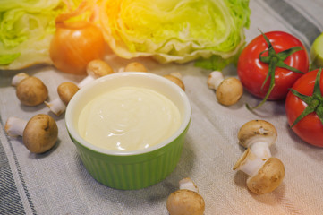 Natural mayonnaise ingredients and the sauce itself. Creamy Mushrooms Sauce inside Bowl. Fresh sauce with herbs, mushrooms, tomatoes and onion. 