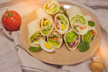 Ready burritos with chicken, cheese and vegetables. Turkish Shawarma durum, traditional sish kebab. Lavash and pieces of vegetables. Green onion, olives and cucumber. Vegetarian snack ideas.