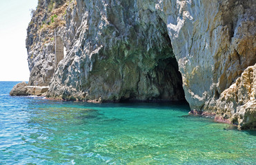 Entrance to the Green grotto with colourful walls and emerald water