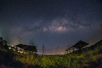 Fototapeta na wymiar Milkyway over the outdated hut in the early of night at Muadzam Shah, Pahang, Malaysia ( Visible noise due to high ISO, soft focus, shallow DOF, slight motion blur)