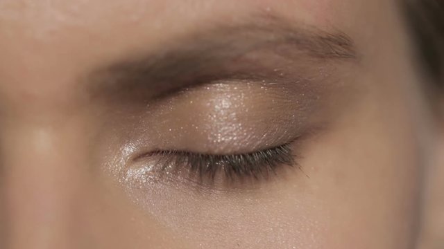 Beautiful female eye: close up opening and closing, version 1