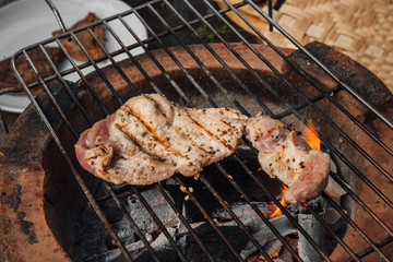 Roast pork steak on a charcoal stove.Steps to make a steak.