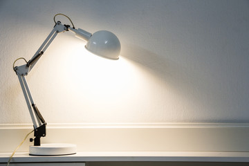 White lamp on the desk.