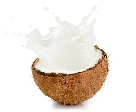 coconut milk spilling out of an half fruit