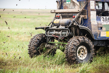 Custom built off road racing car passes at high speed.