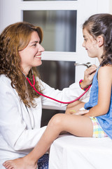 Fototapeta premium Doctor examining a child girl