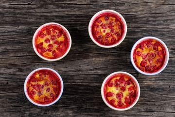 portions of Cherry clafouti in ceramic ramekins