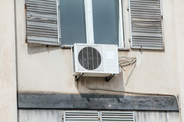 Air conditioning, exterior unit on the facade of the old building, close up. Facade of a house with...