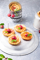 Apple caramel little tarts on grey background. French tatin with paradise apple.