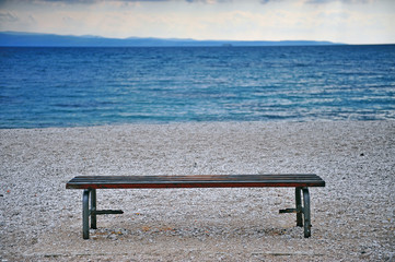 Lonely bench at the sea coast