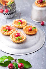 Apple caramel little tarts on grey background. French tatin with paradise apple.