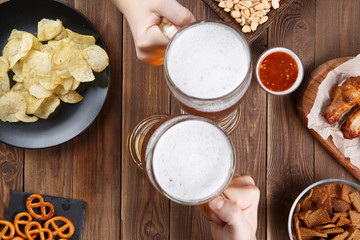 Appetizers and beer on the table for watch the football match.