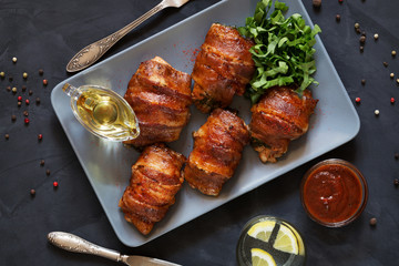 Chicken breasts rolled in bacon on grey tray