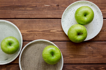 fresh organic green fruits with apples on wooden background top view