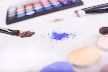 Professional makeup brushes and tools. Makeup products set on a white background. Colorful frame with various makeup products. Beauty and makeup concept.