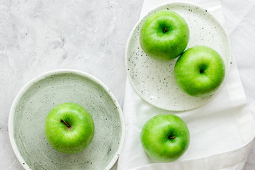 ripe green apples stone table background top view