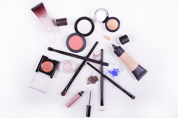 Professional makeup brushes and tools. Makeup products set on a white background. Colorful frame with various makeup products. Beauty and makeup concept.