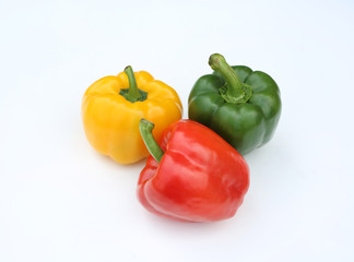 Green, red and yellow bell pepper isolated on white background.