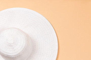 Fototapeta na wymiar Female straw hat on a beige background