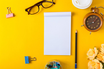 Office equipment on a yellow and golden paper desk