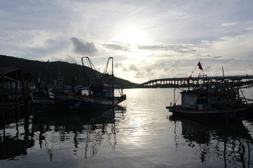 Sea landscape Sky and fishing boats are docked. Evening sun makes a beautiful appearance with reflection.