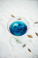 close up of blue cool refreshing summer cocktail drink with ice