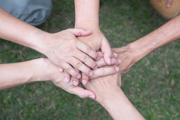 young college student joining hand, start up business team touching hands together - unity, harmony, teamwork, friendship concept