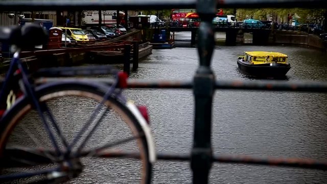 AMSTERDAM 2017 Boat passing by a bridge in Amsterdam canal