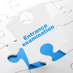 Education concept: Entrance Examination on puzzle background